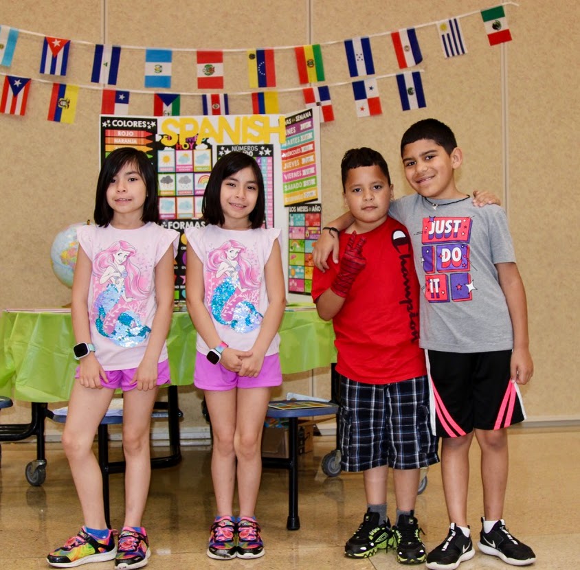 Four children attending a Sycamore Creek Elementary Love Our Languages Fair