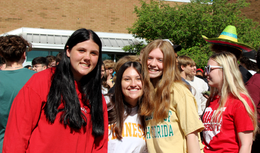 high school girls smiling at the camera during the 2022 Pickeringtom High School Central Senior Walkout