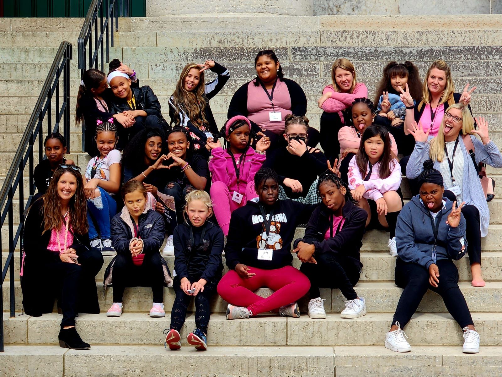 a group of Harmon Middle School students sitting outside on stone steps